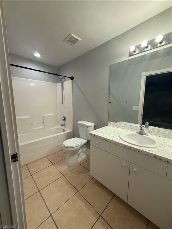 3122 12th Street Southwest Lehigh Acres, FL 33976 - Photo 15 of 19 a bathroom with a double vanity sink a toilet a mirror and shower