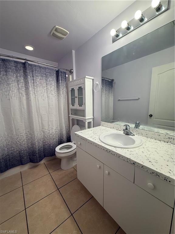3122 12th Street Southwest Lehigh Acres, FL 33976 - Photo 16 of 19 a bathroom with a granite countertop sink a toilet and a mirror