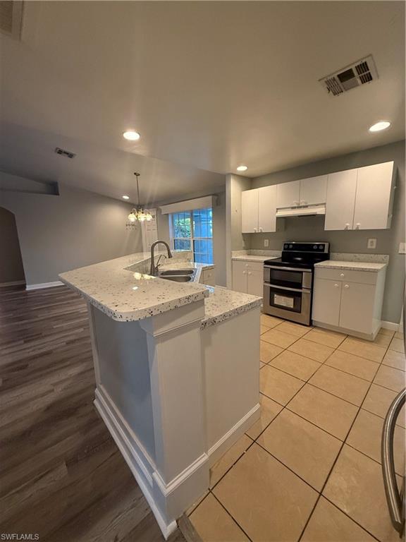 3122 12th Street Southwest Lehigh Acres, FL 33976 - Photo 5 of 19 a kitchen with stainless steel appliances granite countertop a sink and a stove