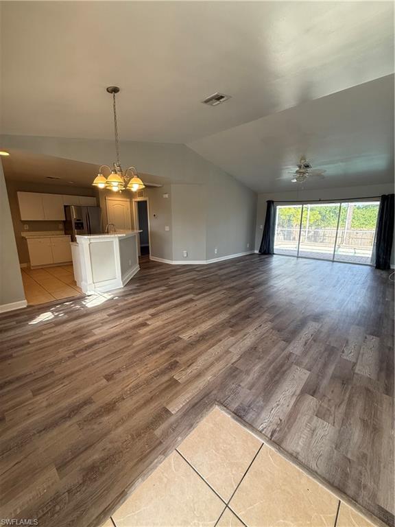 3122 12th Street Southwest Lehigh Acres, FL 33976 - Photo 9 of 19 an empty room with wooden floor and windows