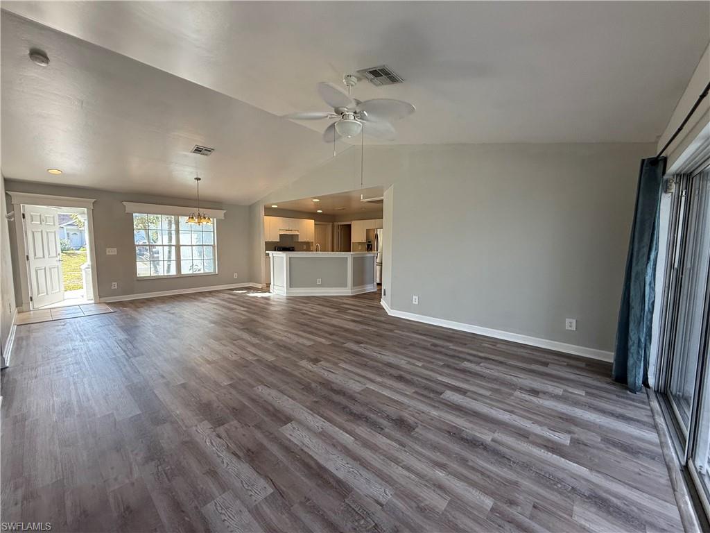 3122 12th Street Southwest Lehigh Acres, FL 33976 - Photo 10 of 19 an empty room with wooden floor and window