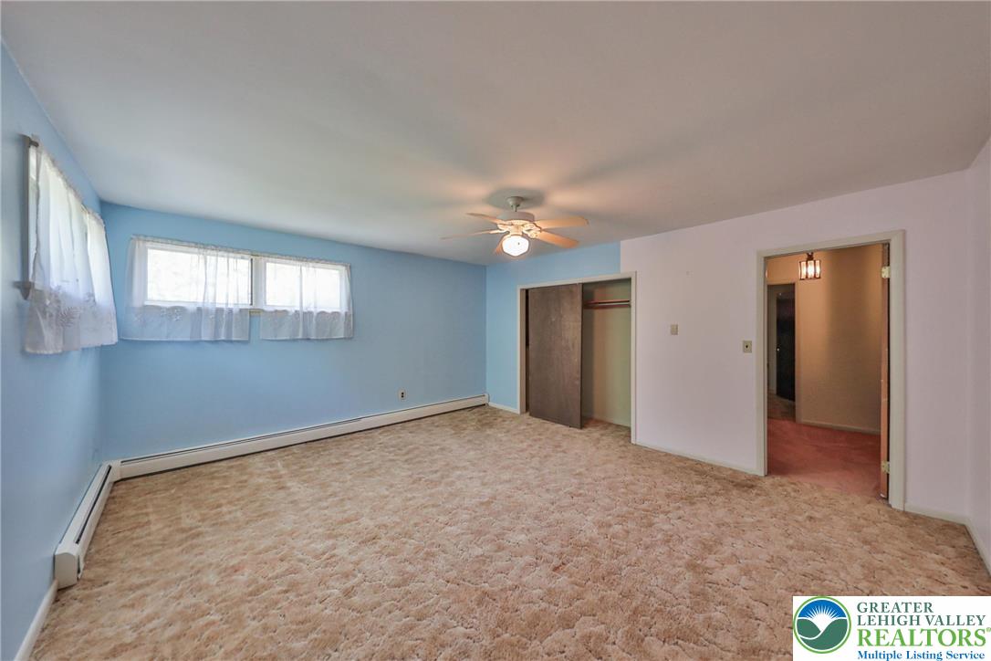 331 Cranberry Creek Road Cresco, PA 18326 - Photo 50 of 95 A well-lit bedroom features plush carpeting and a convenient ceiling fan.