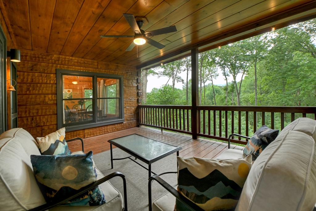 1134 Maggie Chapman Road Blue Ridge, GA 30513 - Photo 32 of 65 a balcony with furniture and wooden floor