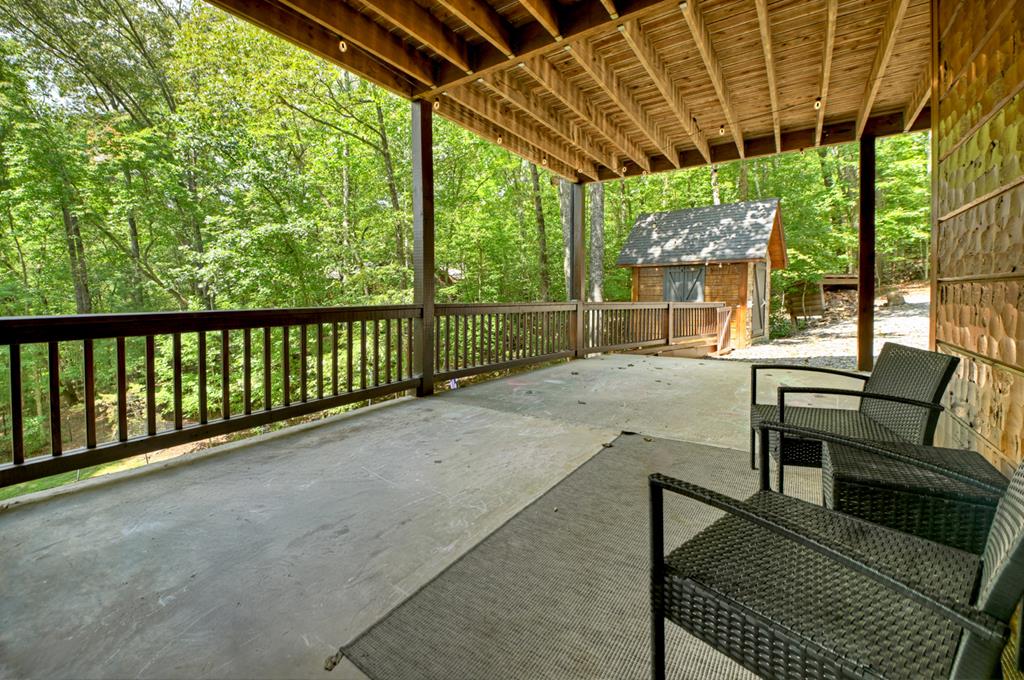 1134 Maggie Chapman Road Blue Ridge, GA 30513 - Photo 35 of 65 a view of a porch with furniture and a backyard