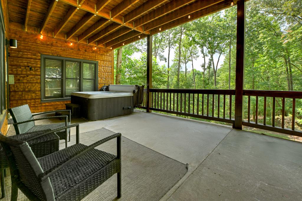 1134 Maggie Chapman Road Blue Ridge, GA 30513 - Photo 36 of 65 a view of a patio with couches chairs and wooden fence