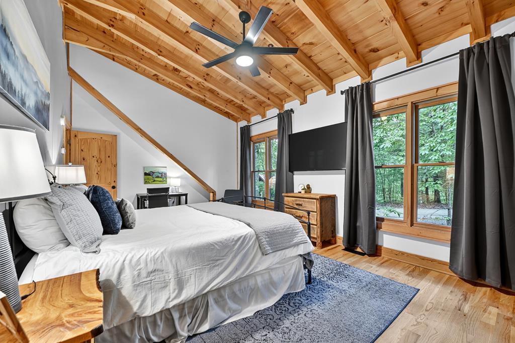1134 Maggie Chapman Road Blue Ridge, GA 30513 - Photo 50 of 65 a bedroom with a bed a flat screen tv and balcony view