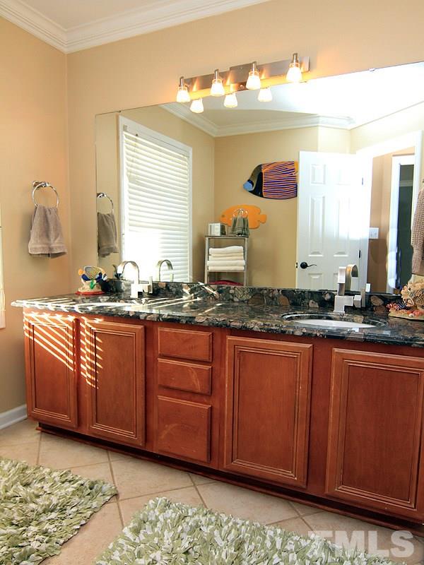 9908 Wyngate Ridge Drive Raleigh, NC 27617 - Photo 16 of 20 Another absolutely beautiful granite countertop in this dual sink vanity. Nice updated faucets as well. Separate water closet and shower space make this hall bath very functional.