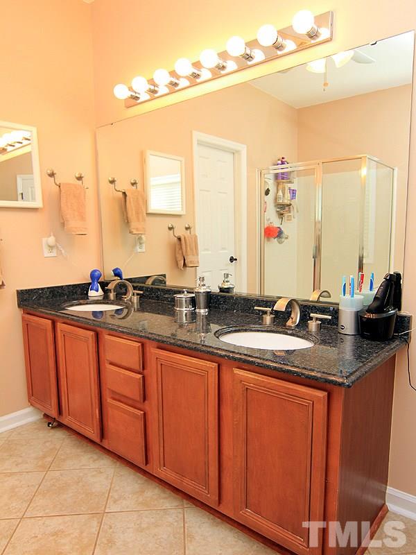 9908 Wyngate Ridge Drive Raleigh, NC 27617 - Photo 10 of 20 Dual sink vanity with gorgeous granite countertop, tile flooring and separate tub/shower plus huge walk-in closet all found here.