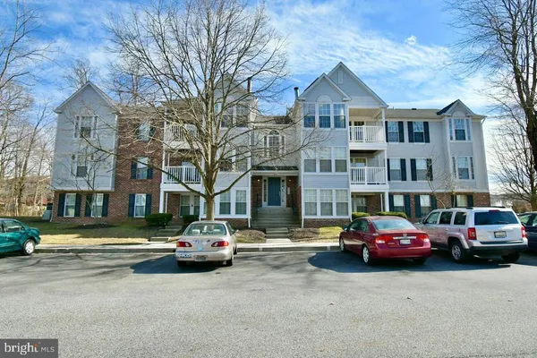 a building with car parked in front of it