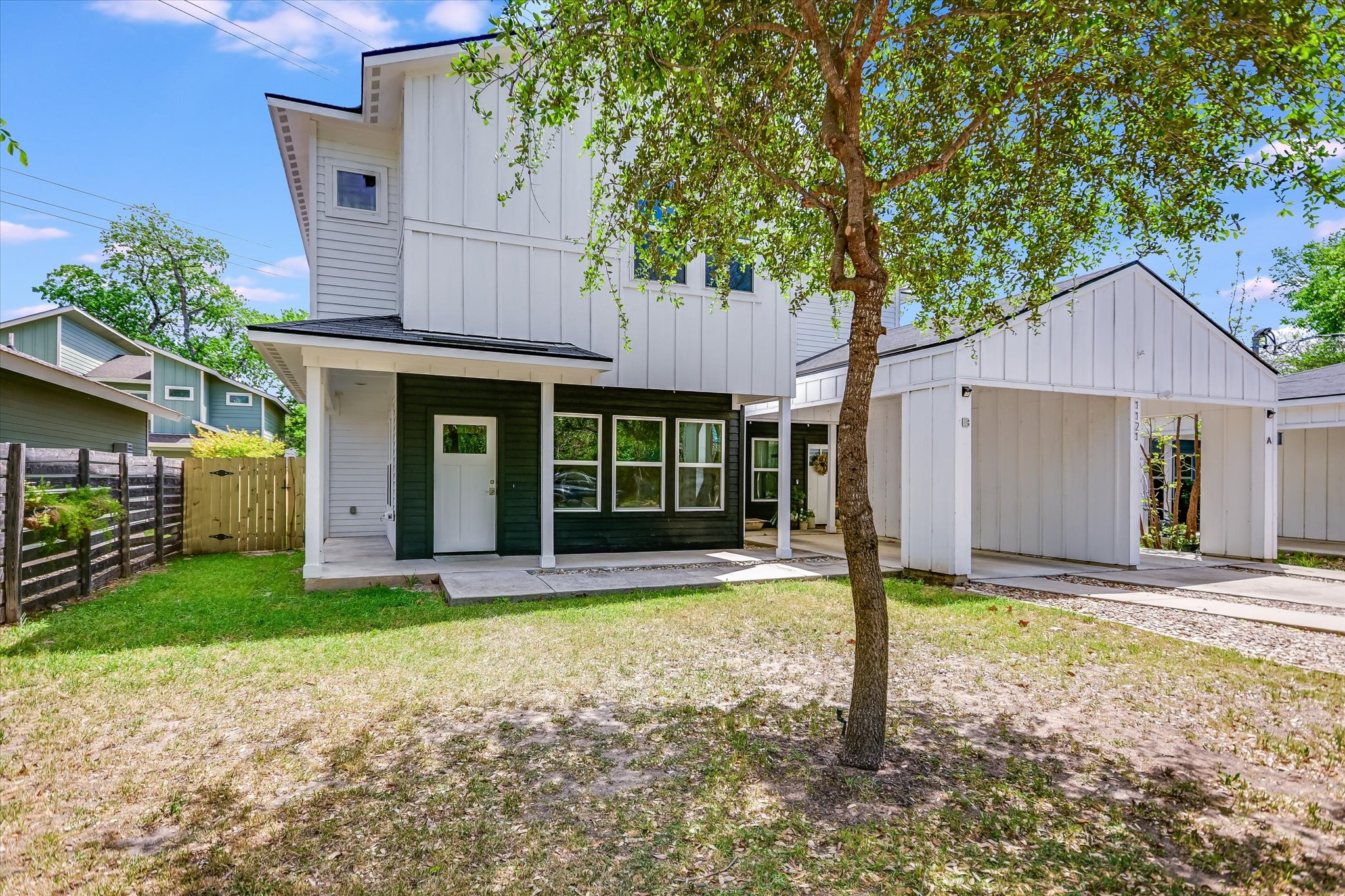1121 Walton Lane, Unit B Austin, TX 78721 - Photo 1 of 18 a front view of a house with garden