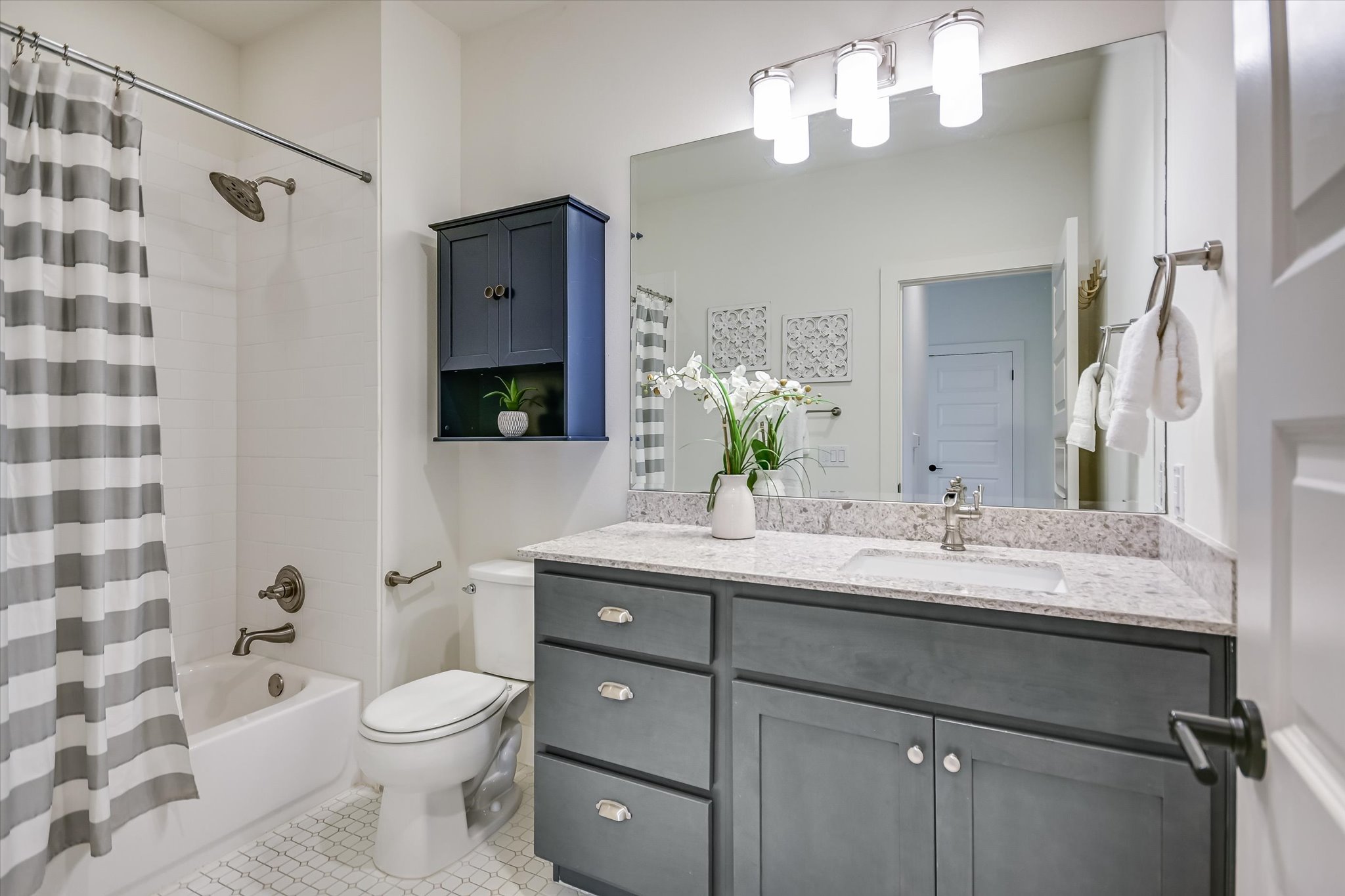1121 Walton Lane, Unit B Austin, TX 78721 - Photo 12 of 18 a bathroom with a sink a toilet and shower