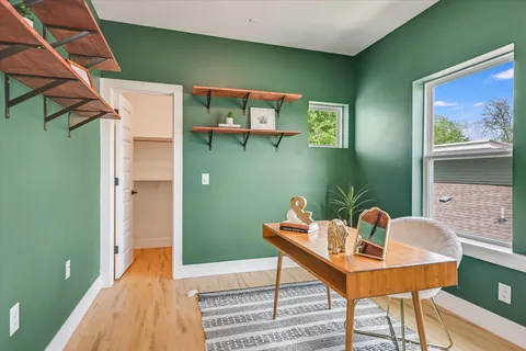 a view of a dining room with a table and chairs