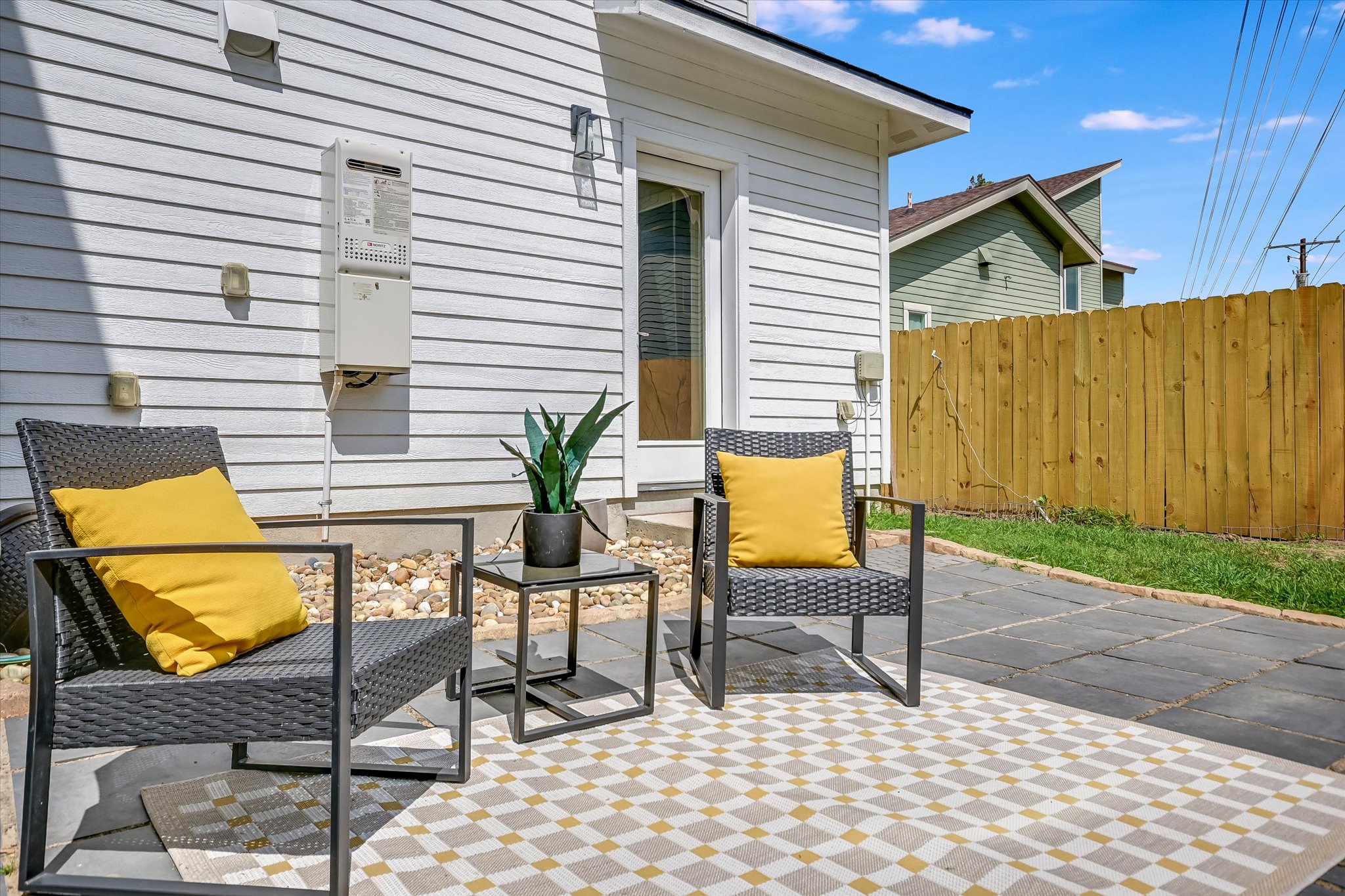 1121 Walton Lane, Unit B Austin, TX 78721 - Photo 14 of 18 a view of a chairs and table in the back yard of the house