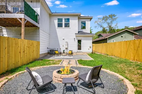 a view of a patio with table and chairs with wooden fence