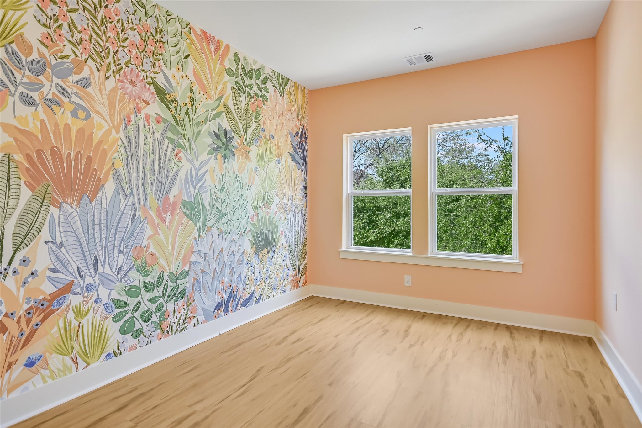 1121 Walton Lane, Unit B Austin, TX 78721 - Photo 10 of 18 a view of an empty room with a window and wooden floor
