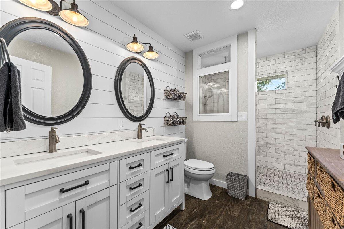 14545 Carriage Lane Red Bluff, CA 96080 - Photo 25 of 67 a bathroom with a granite countertop toilet a sink and a mirror