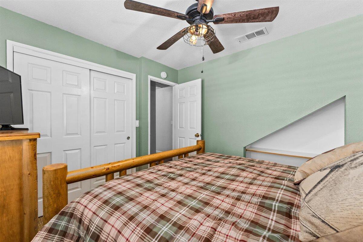 14545 Carriage Lane Red Bluff, CA 96080 - Photo 30 of 67 a bedroom with a bed and a chandelier