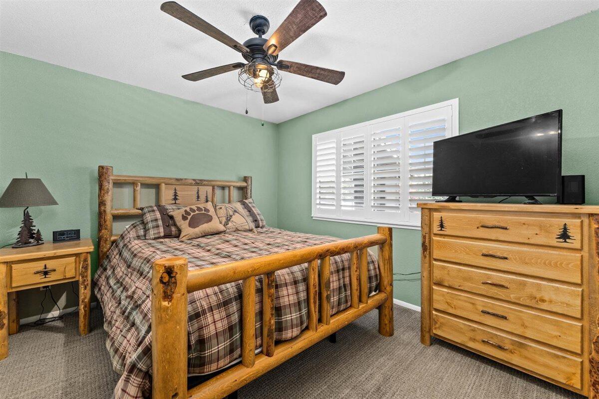 14545 Carriage Lane Red Bluff, CA 96080 - Photo 31 of 67 a bedroom with a bed and a flat screen tv