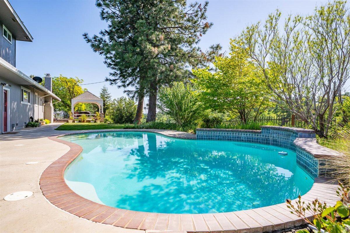 14545 Carriage Lane Red Bluff, CA 96080 - Photo 44 of 67 a view of a swimming pool with a patio
