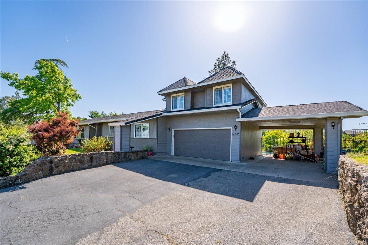 14545 Carriage Lane Red Bluff, CA 96080 - Photo 5 of 67 a front view of a house with a yard and a garage