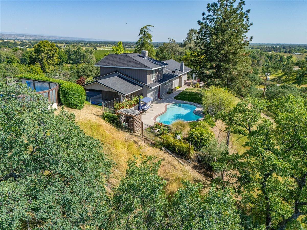 14545 Carriage Lane Red Bluff, CA 96080 - Photo 62 of 67 a view of a house with a big yard and large trees
