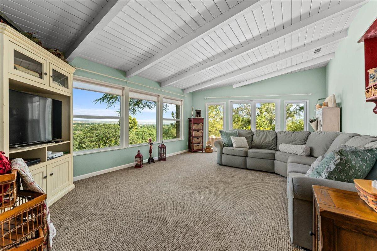 14545 Carriage Lane Red Bluff, CA 96080 - Photo 10 of 67 a living room with furniture a flat screen tv and floor to ceiling window