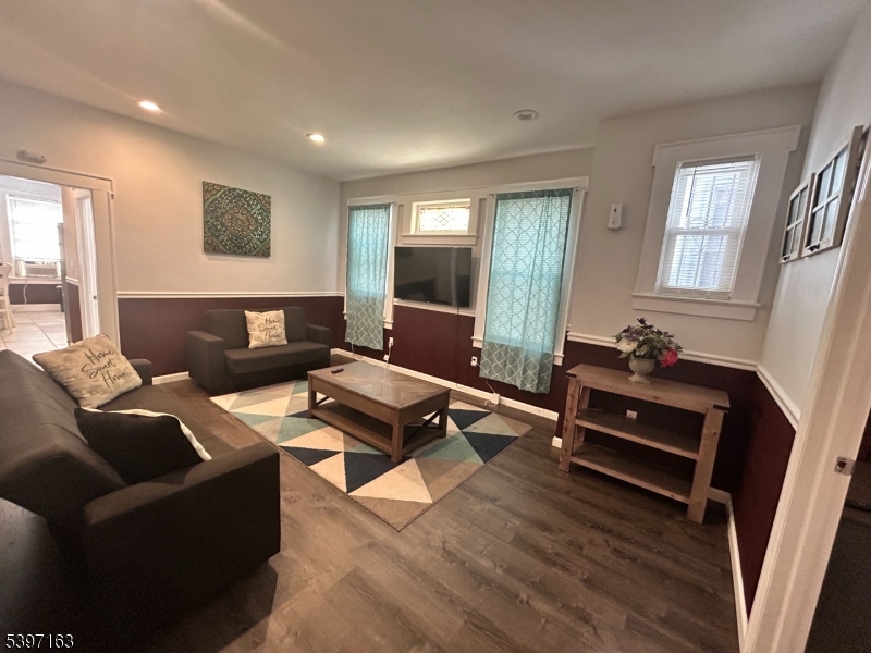 142 Mapes Avenue Newark, NJ 07112 - Photo 2 of 10 a living room with furniture and wooden floor