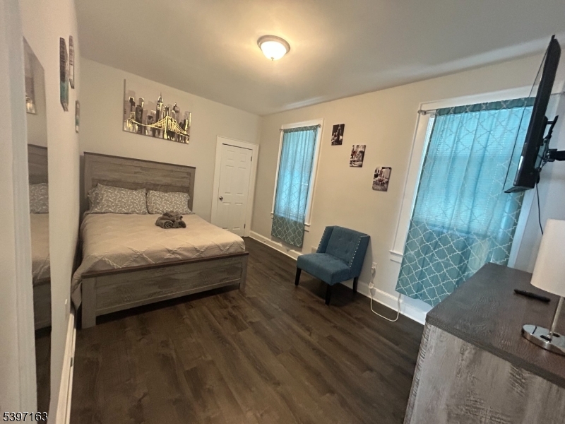 142 Mapes Avenue Newark, NJ 07112 - Photo 6 of 10 a bedroom with a bed and wooden floor