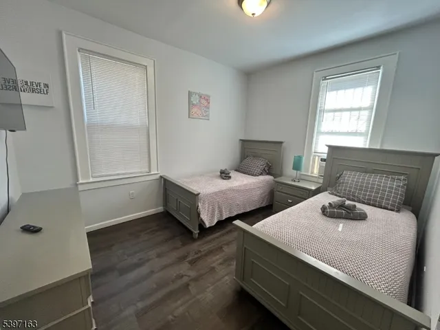 a bedroom with two beds and a window