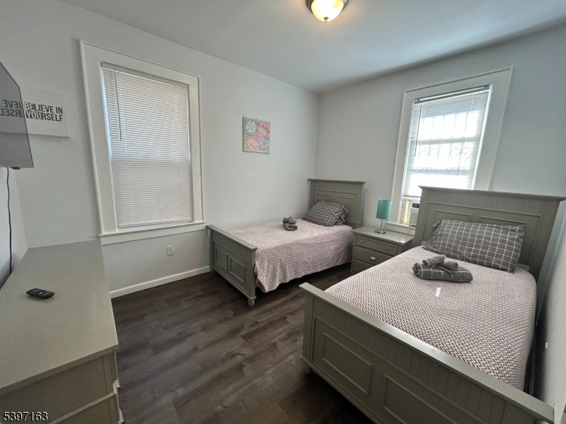 142 Mapes Avenue Newark, NJ 07112 - Photo 9 of 10 a bedroom with two beds and a window