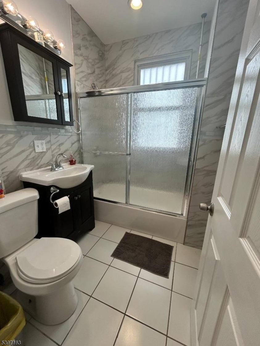 142 Mapes Avenue Newark, NJ 07112 - Photo 10 of 10 a bathroom with a toilet a sink and mirror