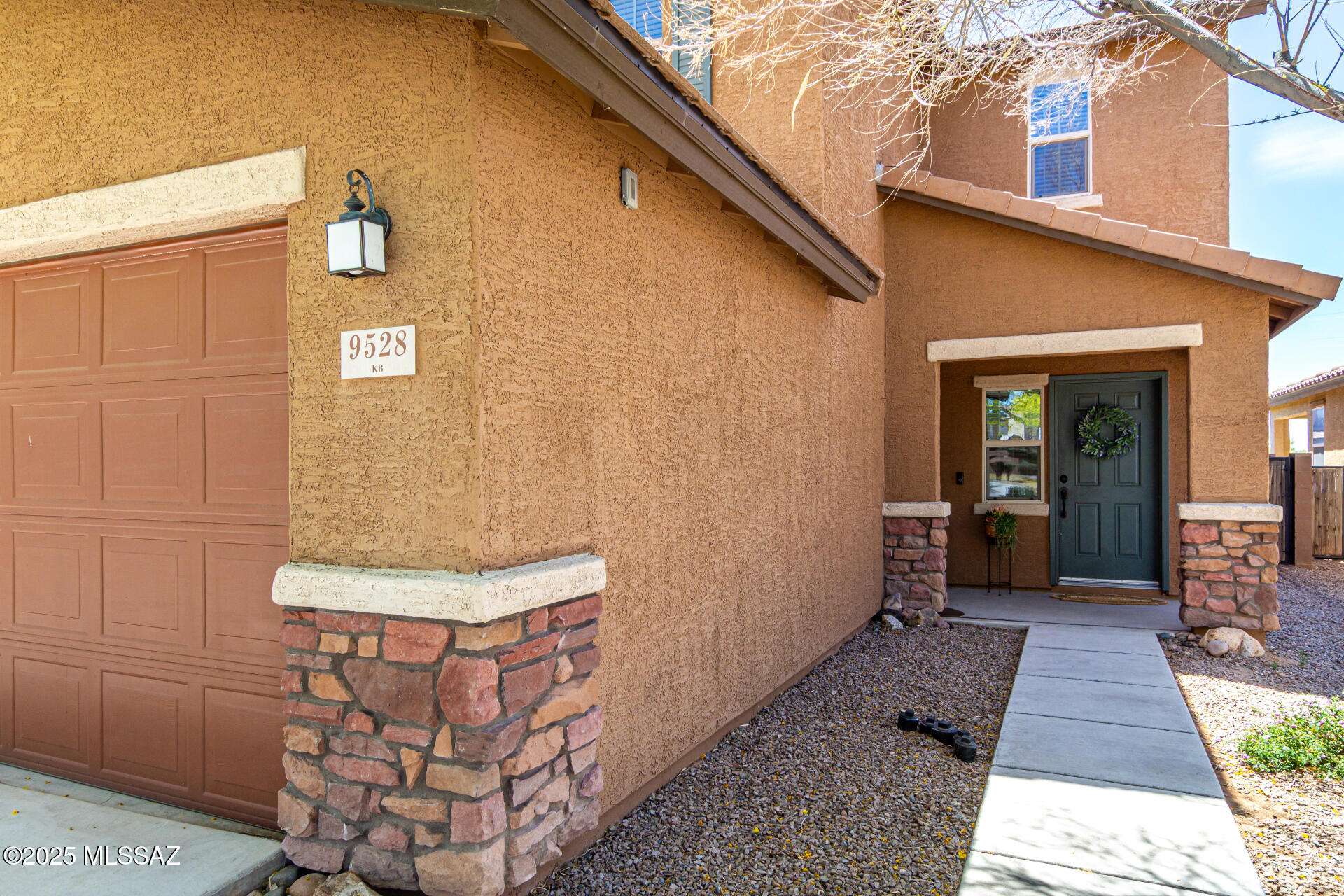 9528 Desert Fauna Loop Tucson, AZ 85747 - Photo 40 of 46 a view of a brick house with many windows