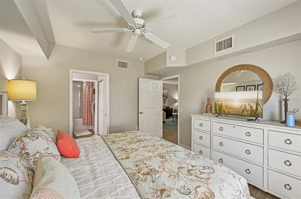 1010 Northwest Fresco Way, Unit 1B01206 Stuart, FL 34994 - Photo 11 of 47 a bedroom with a bed and a dresser