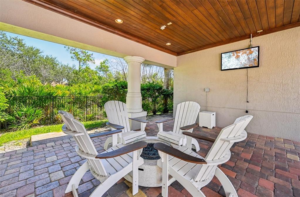 1010 Northwest Fresco Way, Unit 1B01206 Stuart, FL 34994 - Photo 34 of 47 a view of a patio with a table chairs and a barbeque