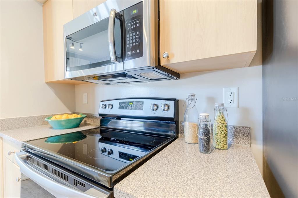 1010 Northwest Fresco Way, Unit 1B01206 Stuart, FL 34994 - Photo 6 of 47 a kitchen view with a stove and a microwave