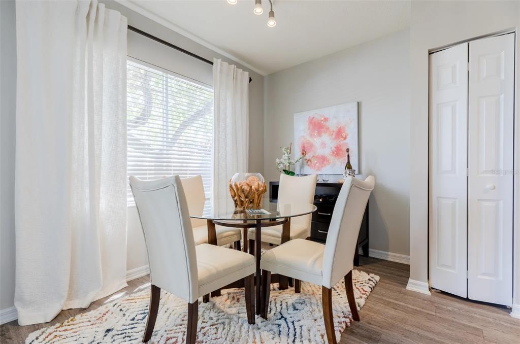 1010 Northwest Fresco Way, Unit 1B01206 Stuart, FL 34994 - Photo 10 of 47 a view of a dining room with furniture and wooden floor