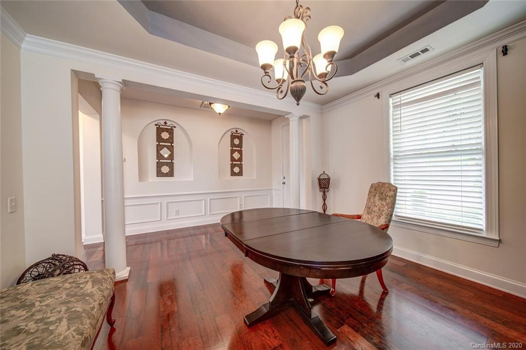 9510 Ridgeforest Drive Charlotte, NC 28277 - Photo 13 of 46 a view of a dining room with furniture wooden floor and chandelier