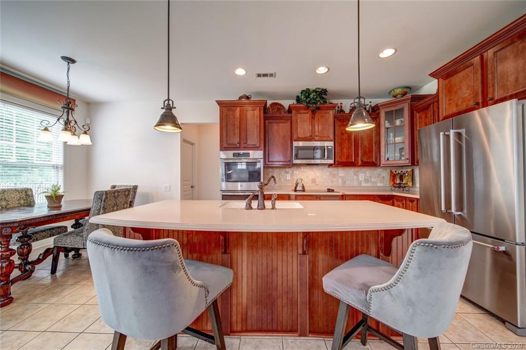 9510 Ridgeforest Drive Charlotte, NC 28277 - Photo 14 of 46 a dining table chairs and a refrigerator