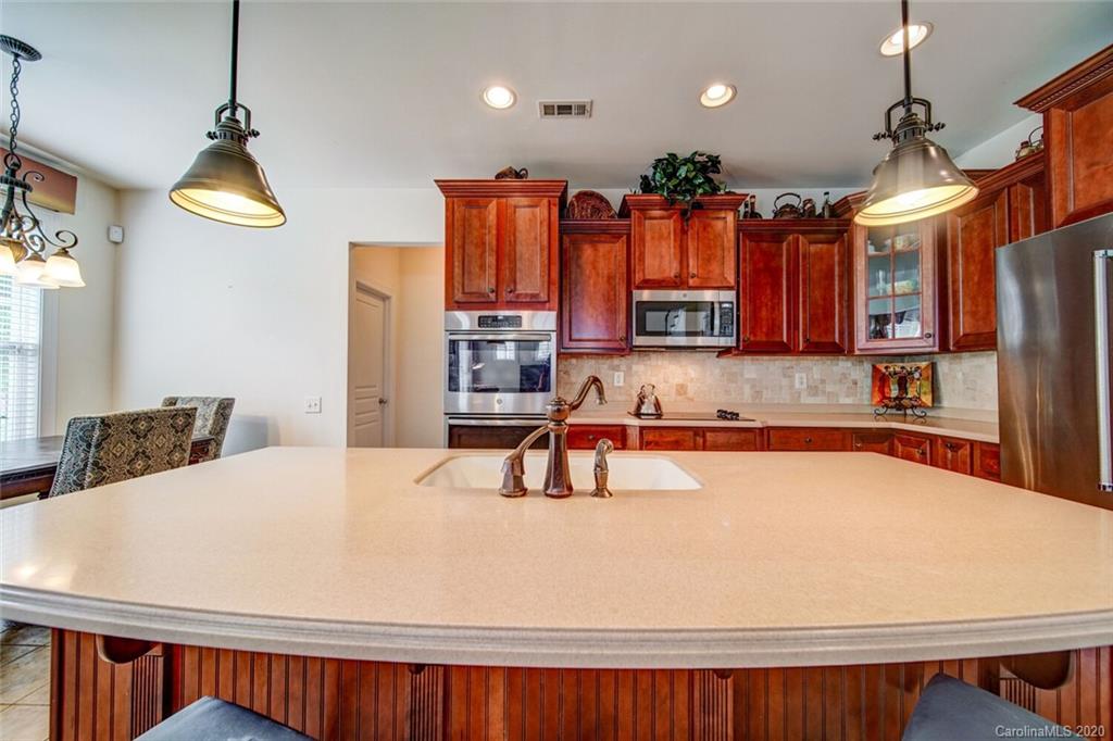9510 Ridgeforest Drive Charlotte, NC 28277 - Photo 16 of 46 a kitchen with a refrigerator and a sink