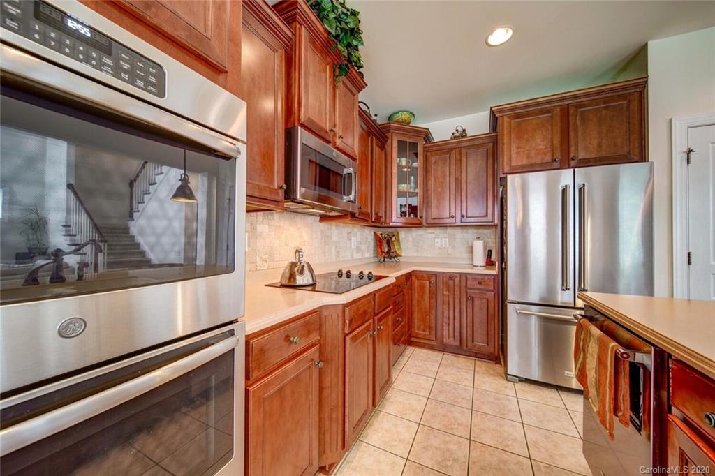 9510 Ridgeforest Drive Charlotte, NC 28277 - Photo 17 of 46 a kitchen with stainless steel appliances a refrigerator and a stove top oven