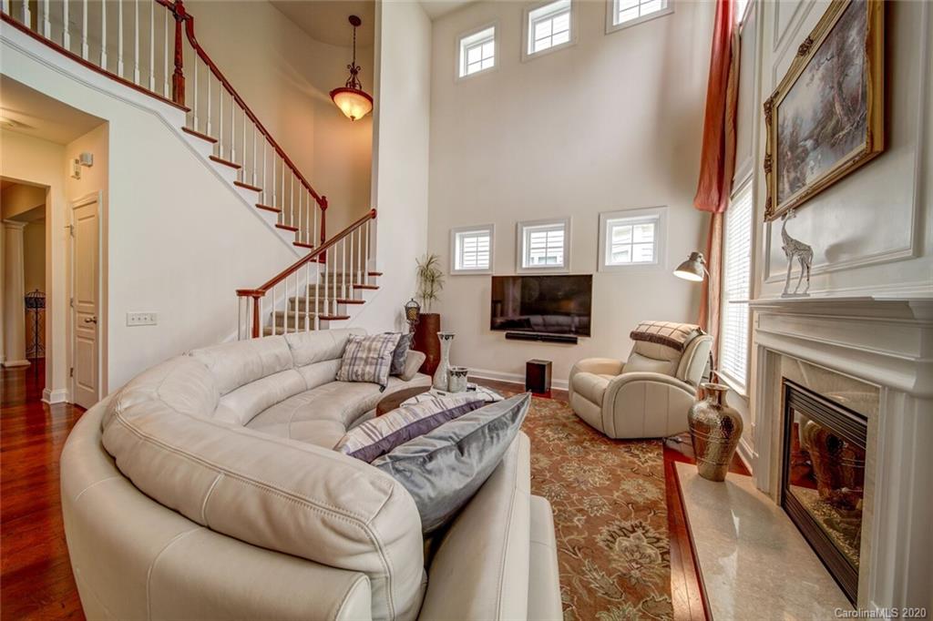 9510 Ridgeforest Drive Charlotte, NC 28277 - Photo 27 of 46 a living room with furniture a flat screen tv and a fireplace
