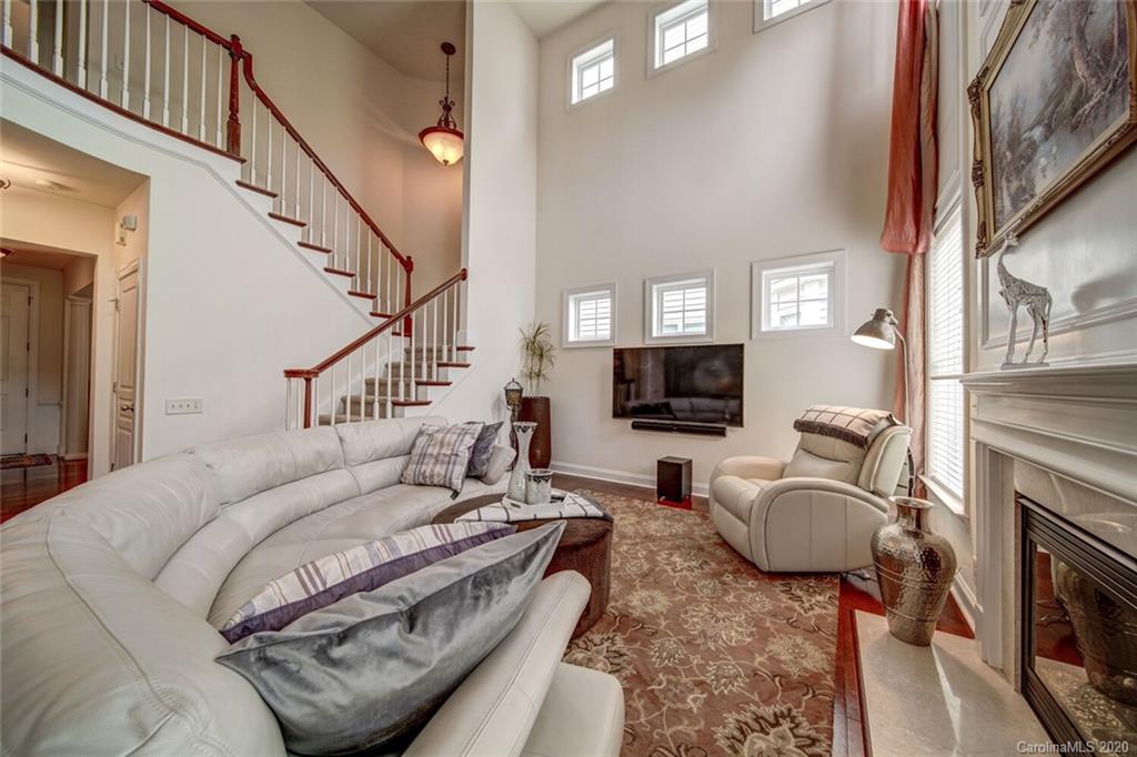9510 Ridgeforest Drive Charlotte, NC 28277 - Photo 30 of 46 a living room with furniture a flat screen tv and a fireplace