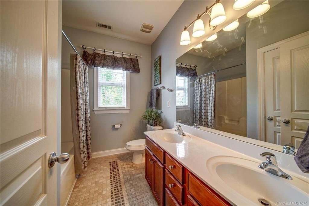 9510 Ridgeforest Drive Charlotte, NC 28277 - Photo 35 of 46 a bathroom with a granite countertop sink mirror vanity and a toilet