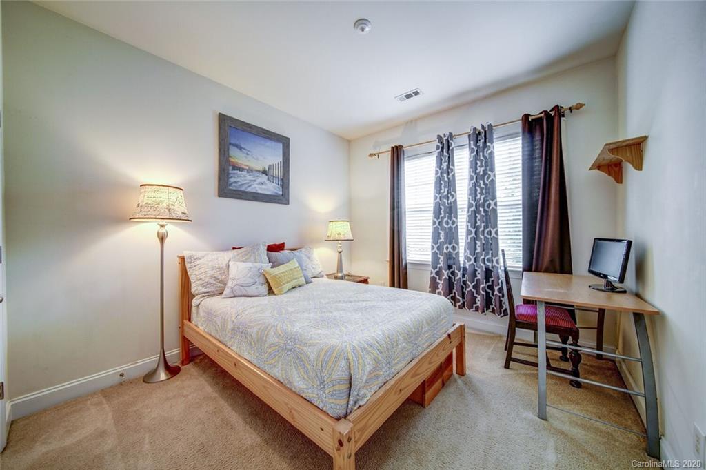 9510 Ridgeforest Drive Charlotte, NC 28277 - Photo 36 of 46 a bedroom with a bed lamp and a large window