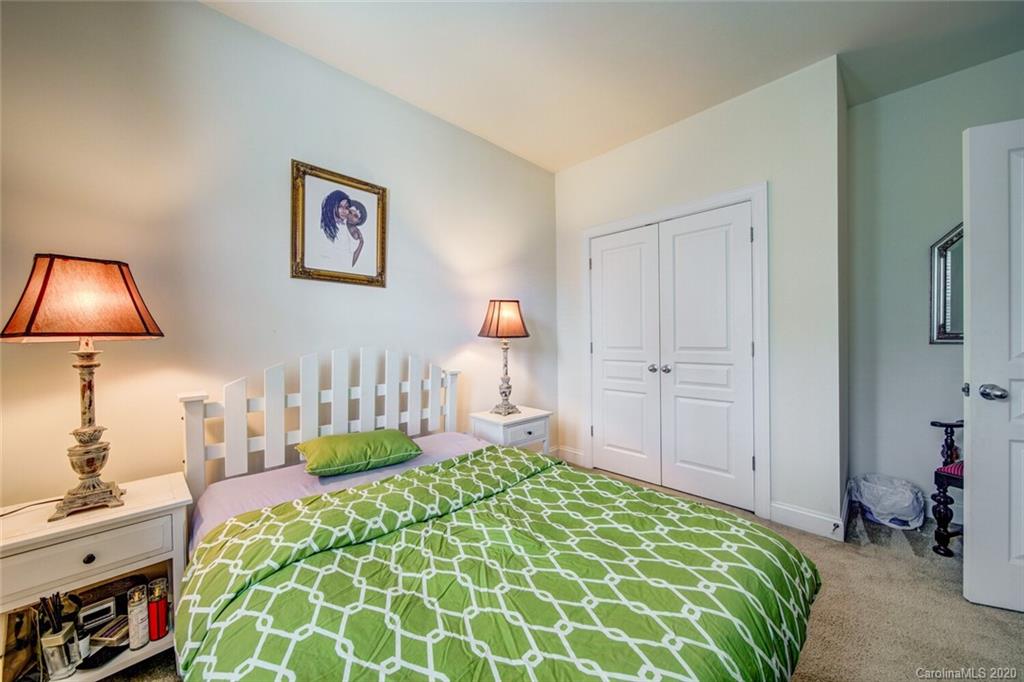 9510 Ridgeforest Drive Charlotte, NC 28277 - Photo 38 of 46 a bedroom with a bed and a lamp on the dresser