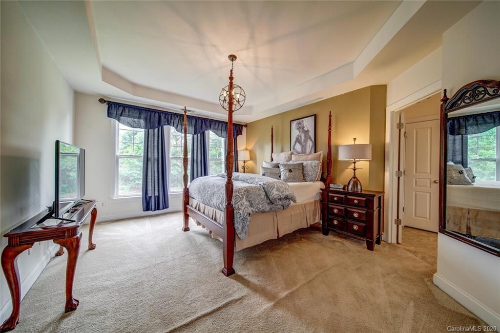 9510 Ridgeforest Drive Charlotte, NC 28277 - Photo 41 of 46 a bedroom with a bed and a chandelier