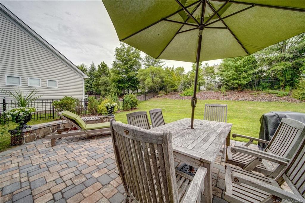 9510 Ridgeforest Drive Charlotte, NC 28277 - Photo 43 of 46 a view of a patio with a table chairs and a umbrella
