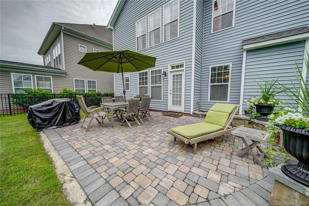 9510 Ridgeforest Drive Charlotte, NC 28277 - Photo 44 of 46 a view of a patio with a table and chairs under an umbrella