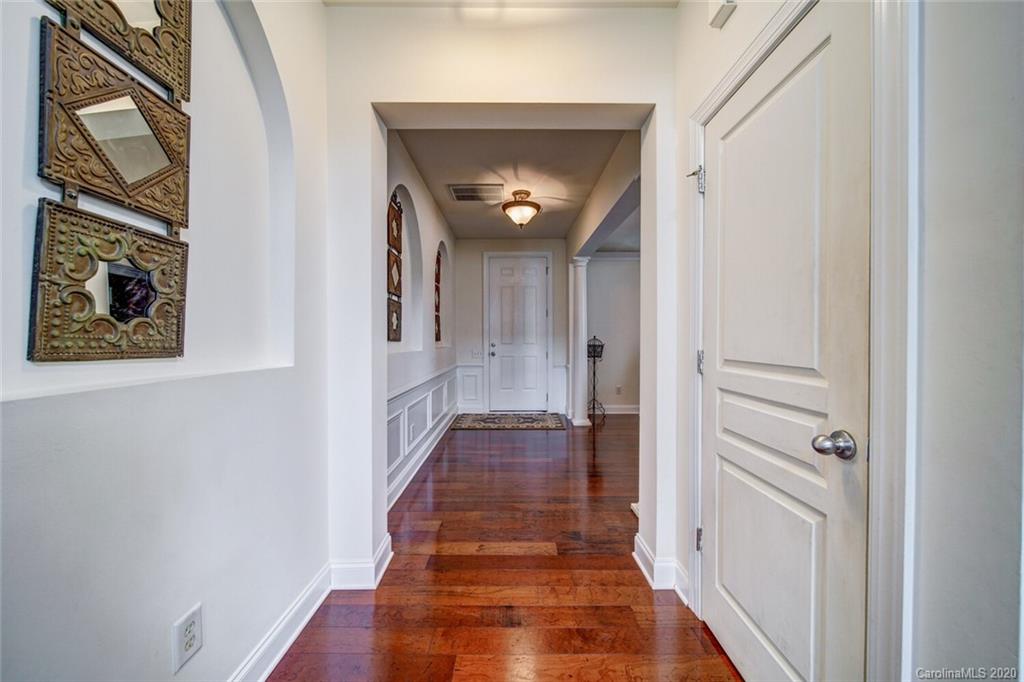 9510 Ridgeforest Drive Charlotte, NC 28277 - Photo 9 of 46 a view of a hallway with wooden floor and a bathroom
