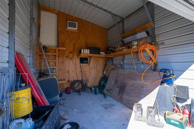 a view of a house with a patio and a car parked fire pit